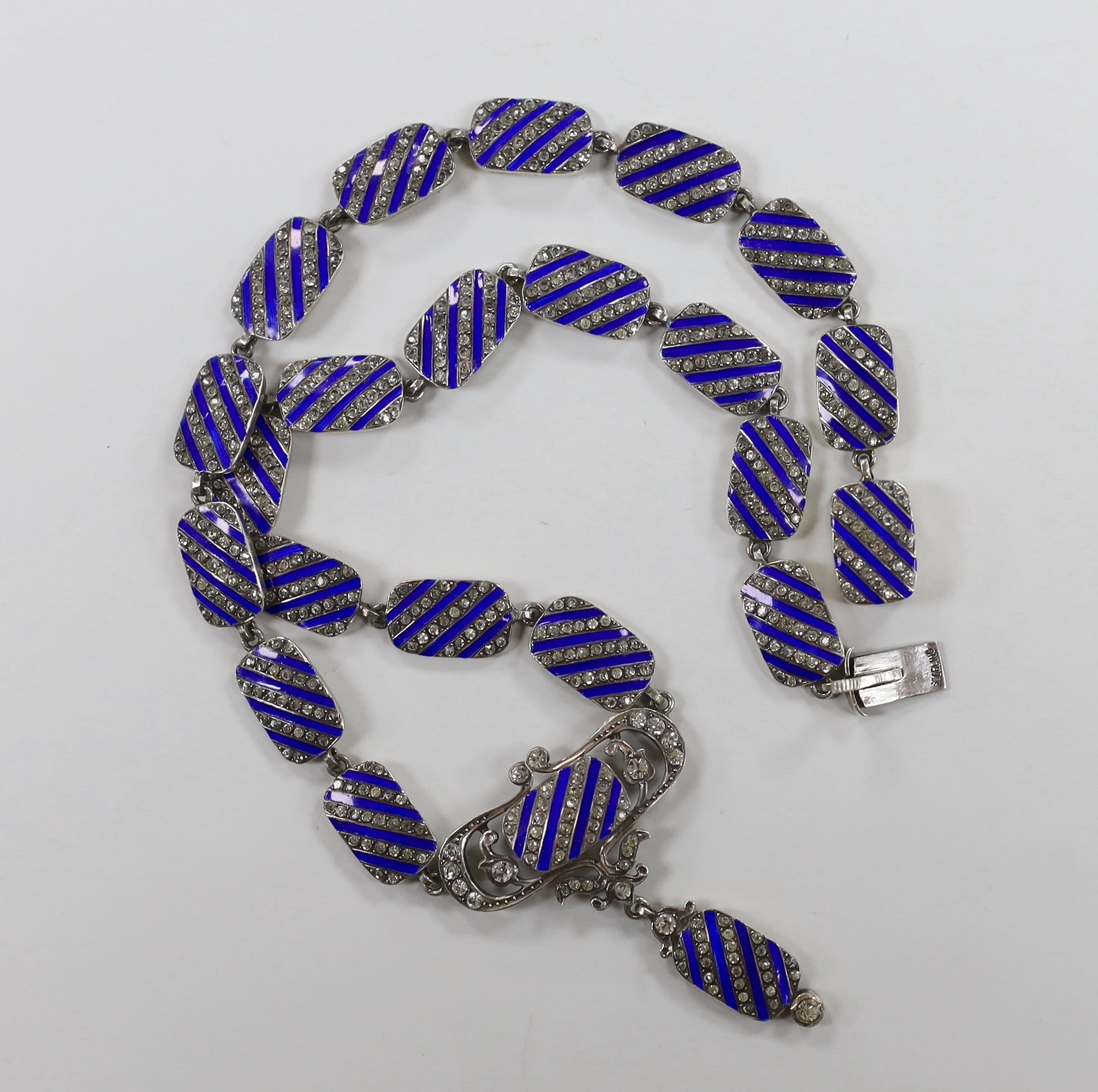 A stylish sterling, paste and blue enamel set drop pendant necklace, overall 43cm.